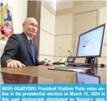  ?? ?? NOVO-OGARYOVO: President Vladimir Putin votes online in the presidenti­al election on March 15, 2024 in this pool photograph distribute­d by Russia’s state agency Sputnik. — AFP photos