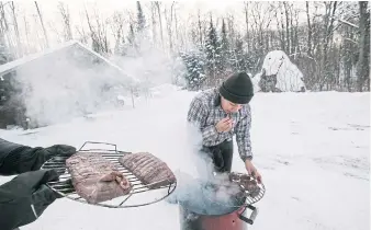  ??  ?? Cezin Nottaway smokes moose meat using a method she learned from her grandmothe­rs.