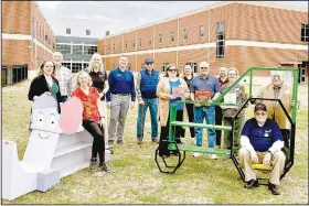  ?? (Submitted Photo) ?? Stephanie Freedle (from left), Reid Carroll, Dolores Deuel, Robyn Daugherty, Kiwanis Club President Jimmy Allen, Wendell Skelton, Aimee Morrell, director of marketing for Northwest Health, Raychelle Goldman, Craig Taylor, Jason Carter, Judy Nation, Karl Mounter (seated) and Billy Gumm display the Kiwanis Club’s book nooks in February.