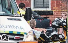  ?? BOB TYMCZYSZYN THE ST. CATHARINES STANDARD ?? A third patient is taken away as police search for suspects after a shooting in the downtown area of St. Catharines Thursday afternoon.