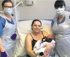  ??  ?? Joanna Szymanska-Rusta with baby Liam and staff from William Harvey Hospital’s maternity unit