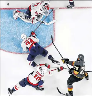  ?? AP PHOTO ?? Vegas Golden Knights’ Ryan Reaves, lower right, scores on Washington Capitals goaltender Braden Holtby as Capitals’ Brett Connolly, lower left, and John Carlson defend during the third period Monday in Game 1 of the Stanley Cup Finals in Las Vegas. The...