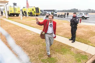  ?? VASHA HUNT/ASSOCIATED PRESS ?? A smiling coach Nick Saban waves to fans greeting the Alabama football team’s return home Tuesday at Tuscaloosa National Airport on Tuesday. The No. 1 Crimson Tide defeated Ohio State 52-24 to win the national title on Monday.