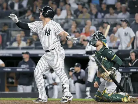  ?? Al Bello/Getty Images ?? New York’s Luke Voit watches the flight of his two-run triple in the sixth inning of the AL wild-card game Wednesday night in New York. It was part of a four-run inning that broke the game open for the Yankees.