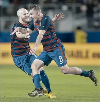 ?? Ben Margot Associated Press ?? JORDAN MORRIS (8) celebrates with U.S. teammate Michael Bradley after scoring late in the second half against Jamaica at Levi’s Stadium, not far from where Morris starred for Stanford.