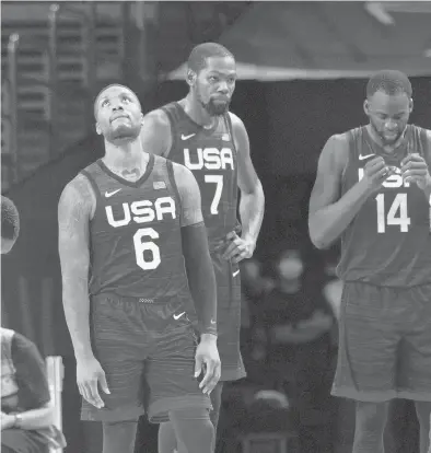  ?? ERIC GAY/AP ?? United States’ Damian Lillard (6), Kevin Durant (7), and Draymond Green (16) wait for play to resume during Sunday’s loss to France.