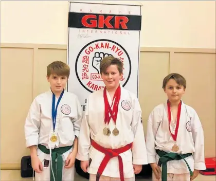  ??  ?? Billie McPharlane, Luke Edwards and Shentay Emke with their silver medals for team kata.