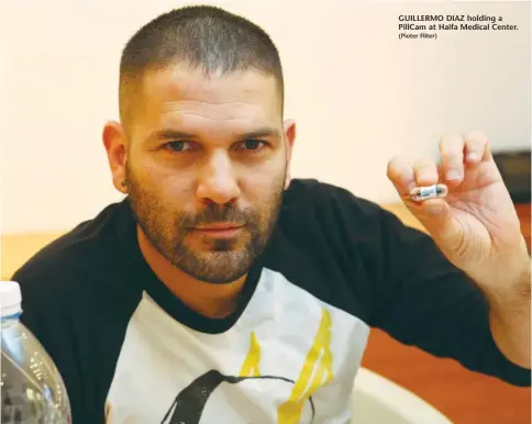  ??  ?? GUILLERMO DIAZ holding a PillCam at Haifa Medical Center.