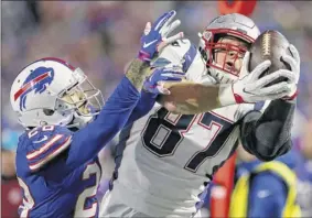  ?? Jeffrey t. Barnes / Associated Press ?? new england Patriots tight end rob Gronkowski, right, makes a catch against Buffalo Bills defensive back Phillip Gaines during the second half on monday night in orchard Park. Gronkowski had three catches for 43 yards.