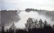  ?? CHRIS KAUFMAN/THE APPEAL-DEMOCRAT VIA AP ?? Water gushes down the Oroville Dam’s main spillway Wednesday in Oroville, Calif.