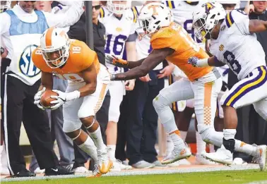  ?? STAFF FILE PHOTO BY ROBIN RUDD ?? Tennessee defensive back Nigel Warrior picks up a Tennessee Tech fumble during the Vols’ homecoming game last November. Warrior and the rest of the secondary are working under a new position coach this spring, with Charlton Warren instructin­g the group.