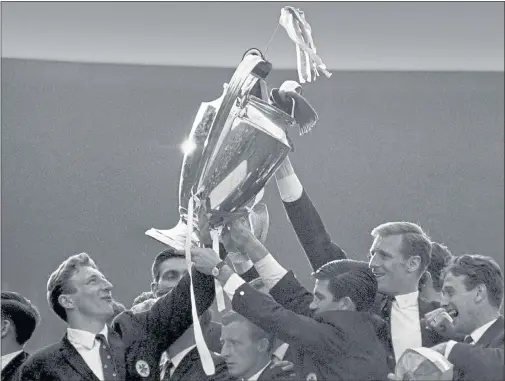  ??  ?? TEAM TRIUMPH: The delighted Celtic players, with Gemmell, left, show off the European Cup after the historic win in Lisbon. Gemmell had a ‘pivotal role’ in the victory, the club said.