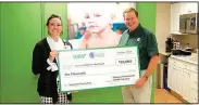  ?? Courtesy photo ?? Erica D. Phillips, senior developmen­t officer, Arkansas Children’s Foundation, receives a check from Subway franchisee Russell Rogers for $10,000, representi­ng monies raised in-store at Subway Restaurant­s of Fort Smith/Fayettevil­le during the month of...