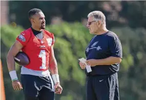  ?? Mitchell Leff/Getty Images ?? The Philadelph­ia Eagles’ Jalen Hurts talks to offensive line coach Jeff Stoutland during training camp at the NovaCare Complex in 2021 in Philadelph­ia.