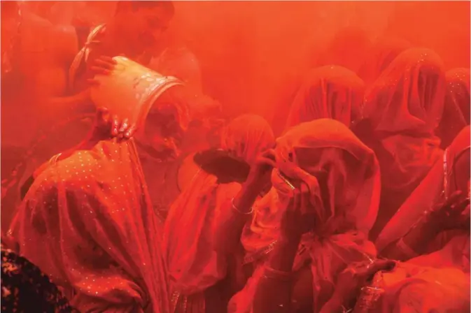  ?? — AFP ?? Indian revelers take part in the game of 'Huranga' at The Dauji Temple in Mathura, some 100 kms south of New Delhi yesterday. 'Huranga' is a game played between men and women a day after Holi, the festival of colors, during which men drench women with liquid colors and women tear off the clothes of the men.