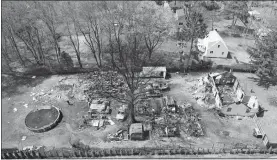  ?? JOHN WOIKE/HARTFORD COURANT VIA AP ?? Emergency personnel work at the scene of an explosion in North Haven on Thursday. A Connecticu­t woman’s call to police to report domestic violence led to a standoff and explosion in a barn behind her home that left at least one person dead and other...