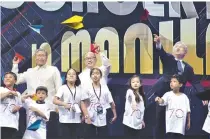  ??  ?? OFFICIALS and schoolchil­dren toss paper planes during the 2019 K-Pop Friendship Concert at the Mall of Asia Arena on March 7.