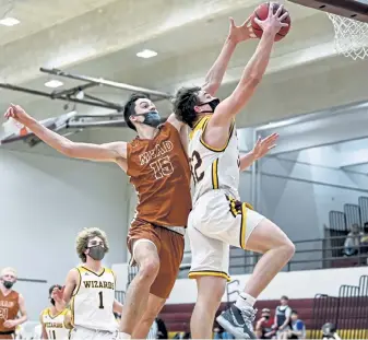  ?? Alex McIntyre, Greeley Tribune ?? Windsor’s Hunter Peck shoots as Mead’s James Shiers defends during a Class 4A game last week. The No. 2 Windsor Wizards defeated the No. 1 Mead Mavericks 69-59.