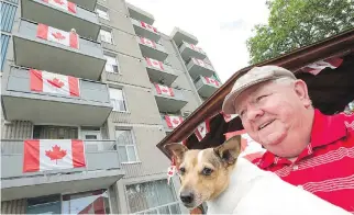  ?? WAYNE CUDDINGTON ?? Henry McCambridg­e, with his dog, Gracie, has led the effort at his Vanier apartment building to cover as many balconies and common areas with as many Canada flags as possible.