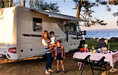  ?? ?? Dining al fresco: Jane and her boys outside their motorhome at the coast