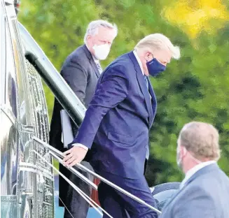  ?? AP PHOTOS ?? President Donald Trump arrives at Walter Reed National Military Medical Center on Friday on Marine One helicopter after he tested positive for COVID-19. White House chief of staff Mark Meadows is at left.