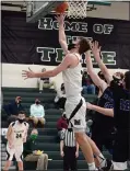  ?? OWEN MCCUE - MEDIANEWS GROUP ?? Methacton’s Ryan Baldwin, center, converts a basket Saturday against CB South in a District 1-6A playoff game.