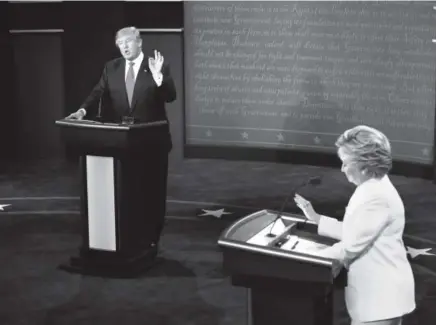  ?? Mark Ralston, AFP/Getty Images ?? Presidenti­al candidates Hillary Clinton and Donald Trump take part in their third and final debate Wednesday night in Las Vegas. Trump told viewers that he would leave the nation in “suspense” about whether he will accept the results from an election...