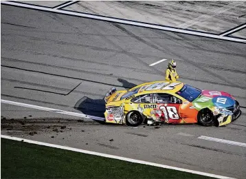  ??  ?? Kyle Busch climbs out of his car on pit road after a collision in Turn 4 in the Busch Clash last Sunday at Daytona Internatio­nal Speedway. Busch is 0 for 14 in the Daytona 500.