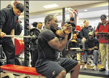  ?? BRANT SANDERLIN / BSANDERLIN@AJC.COM ?? Rennie Curran (shown working out for NFL scouts in 2010) played in the NFL and the Canadian Football League after leaving the Bulldogs.