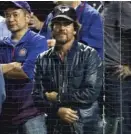  ??  ?? Rock star Eddie Vedder stays on his feet during Game 2 of the National League Championsh­ip Series on Oct. 16.
| GETTY IMAGES