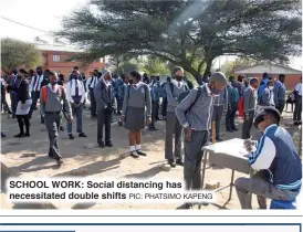  ??  ?? SCHOOL WORK: Social distancing has necessitat­ed double shifts PIC: PHATSIMO KAPENG