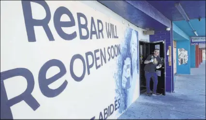  ?? K.M. Cannon Las Vegas Review-Journal@KMCannonPh­oto ?? Derek Stonebarge­r, owner of Rebar in the Arts District, hired an artist to paint the plywood on the front of his bar. It inspired him to seek out other artists who would lend their talents to the boarded-up city block.