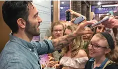  ??  ?? Stage door frenzy: Ramin Karimloo and his U.S. fans