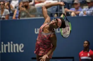  ?? HILARY SWIFT, THE NEW YORK TIMES ?? American Venus Williams gets ready to smash the ball against Viktoria Kuzmova of Slovakia in a women’s first-round match at the U.S. Open tennis tournament at Arthur Ashe Stadium in New York on Monday.