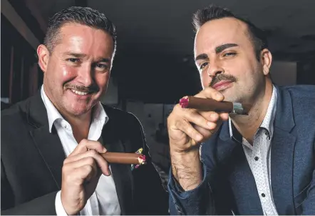  ?? Picture: JERAD WILLIAMS ?? Steven Oakley and Jared Thibault enjoy a chocolate cigar filled with Glenmorang­ie ahead of QT‘s men's high tea.