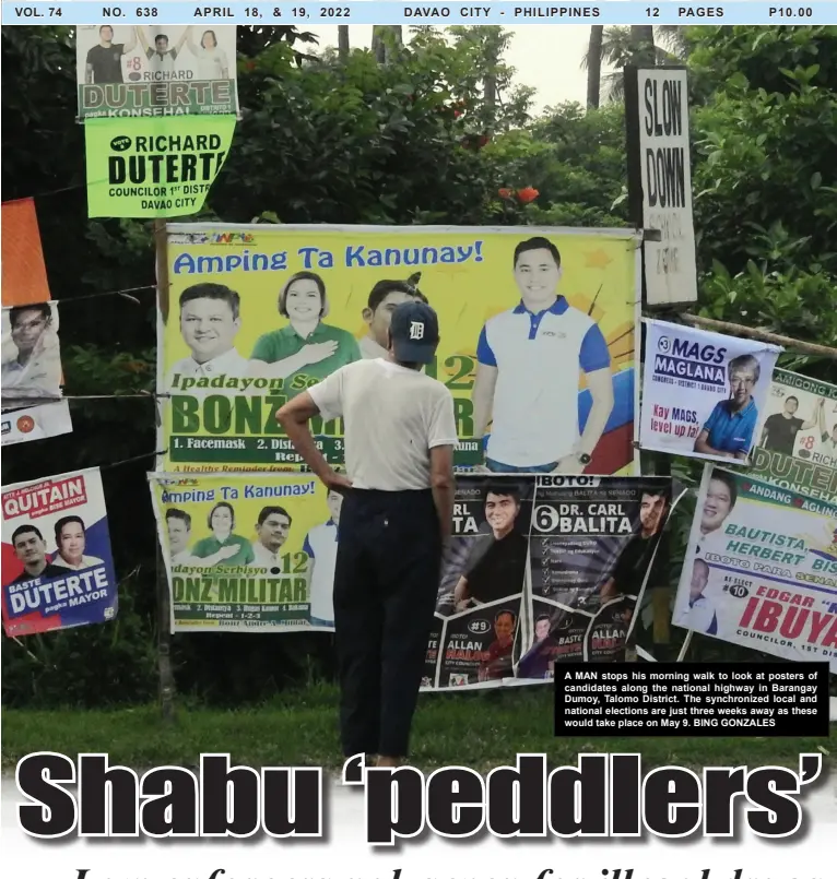  ?? BING GONZALES ?? A MAN stops his morning walk to look at posters of candidates along the national highway in Barangay Dumoy, Talomo District. The synchroniz­ed local and national elections are just three weeks away as these would take place on May 9.