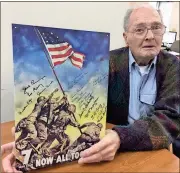  ?? Mike Colombo / Rome News-Tribune ?? Retired Marine Bob Blair of Rome poses with a metal poster of the iconic flag raising on Iwo Jima. The wall sign is signed by 16 Rome area veterans of the battle that occurred on the small island in the Pacific in February and March 1945.