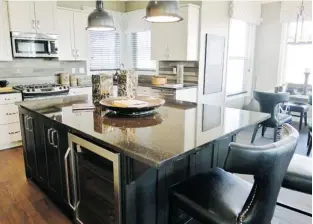  ?? Photos, Claire Young/calgary Herald ?? The kitchen in the Hillsborou­gh 2 show home by Jager Homes in Chestermer­e’s Rainbow Falls.