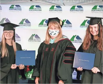  ??  ?? Madison Gaston (left), an early childhood care and education major from Murray County, stands with GNTC President Heidi Popham (center) and sister Kaitlyn Gaston (right), a business management major also from Murray County, after receiving their Associate of Applied Science degrees.