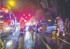  ?? Picture: JERAD WILLIAMS ?? Emergency crews attend a car crash on Smith St on wet Gold Coast night.