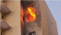  ?? (Sderot Municipali­ty) ?? AN APARTMENT in Sderot catches fire after being directly hit by rocket fire last night.