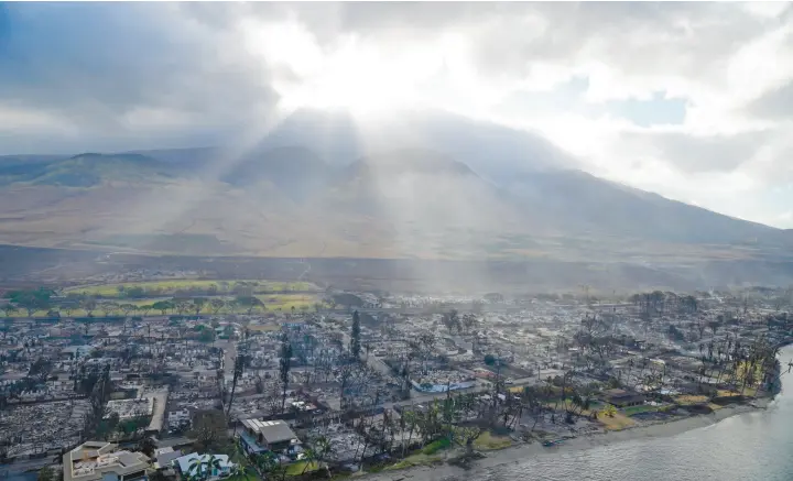  ?? RICK BOWMER/AP ?? Lahaina, Hawaii, is devastated days after Maui’s August wildfires. Conspiracy theorists claim that the fires were set using “energy weapons” developed by the U.S. military.