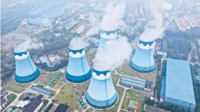  ?? CHINATOPIX ?? Steam billows from cooling towers at a coal-fired power station Sept. 27 in Nanjing, China.