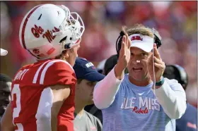  ?? MATTHEW HINTON — THE ASSOCIATED PRESS ?? Mississipp­i head coach Lane Kiffin, right, talks to quarterbac­k Jaxson Dart (2) during the first half an NCAA college football game against LSU in Baton Rouge, La., Saturday, Oct. 22, 2022.