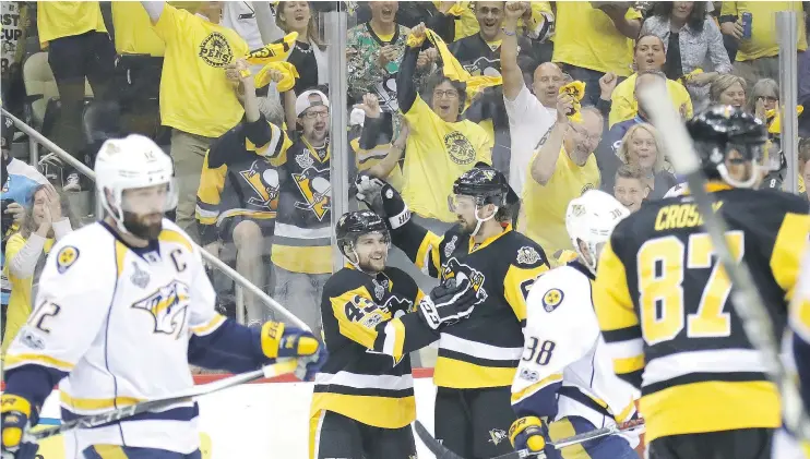  ?? — GETTY IMAGES ?? Conor Sheary of the Pittsburgh Penguins celebrates with Ron Hainsey after scoring a goal in Game 1 of the Stanley Cup Final against the Nashville Predators.