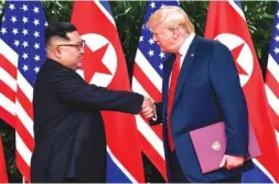  ?? AP PHOTO/SUSAN WALSH ?? North Korean leader Kim Jong Un, left, and U.S. President Donald Trump shake hands at the conclusion of their meetings in June at the Capella resort on Sentosa Island in Singapore. U.S. analysts say they have located more than half of an estimated 20 secret North Korean missile developmen­t facilities.