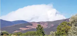  ?? RICK ROMANCITO/TAOS NEWS ?? A plume of smoke from the Ute Park Fire, in Cimarron Canyon in Colfax County, was visible from the Taos area Thursday evening.