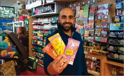  ?? Photo by Russ Olivo ?? Paul Boutros, a manager at CT Plus Convenienc­e Store in Woonsocket, holds up some typical flavored tobacco products, that are the target of a controvers­ial ban implemente­d by the City Council. The store’s owner says he and other merchants will lose...