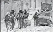  ?? AP ?? This frame grab from video released Tuesday and provided by Furat FM, a Syrian Kurdish activist-run media group, shows U.S.backed Syrian Democratic Forces fighters in the eastern side of Raqqa, Syria.