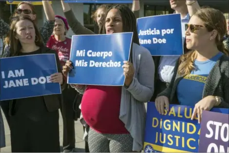  ?? J. SCOTT APPLEWHITE — THE ASSOCIATED PRESS ?? Activists with Planned Parenthood demonstrat­e in support of a pregnant 17-year-old being held in a Texas facility for unaccompan­ied immigrant children to obtain an abortion, outside of the Department of Health and Human Services in Washington, Friday.